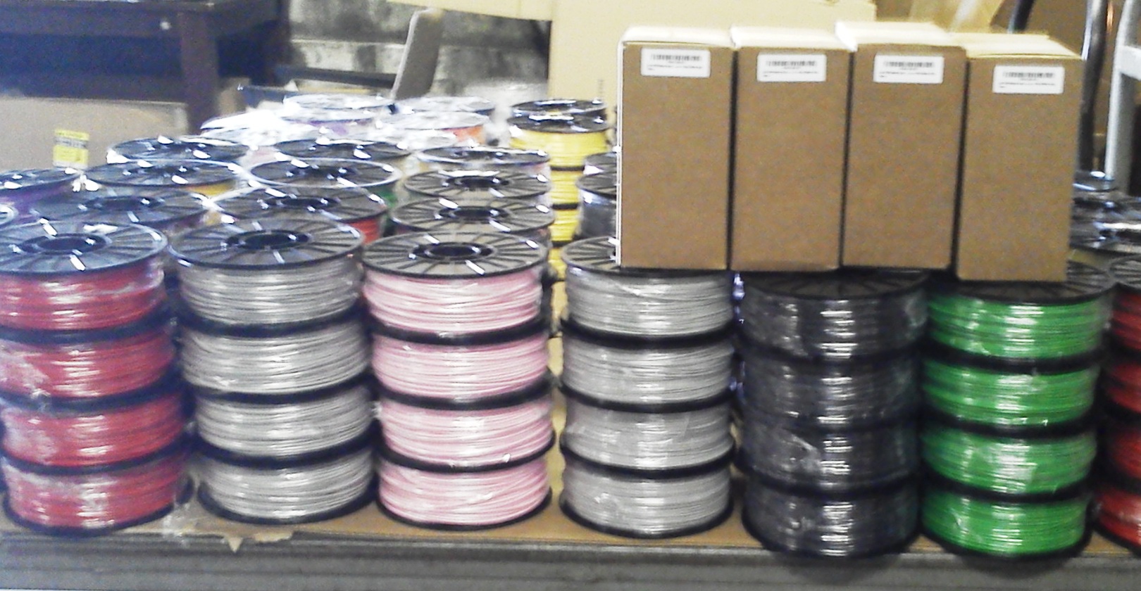 Colored 3D printer filament spools in production